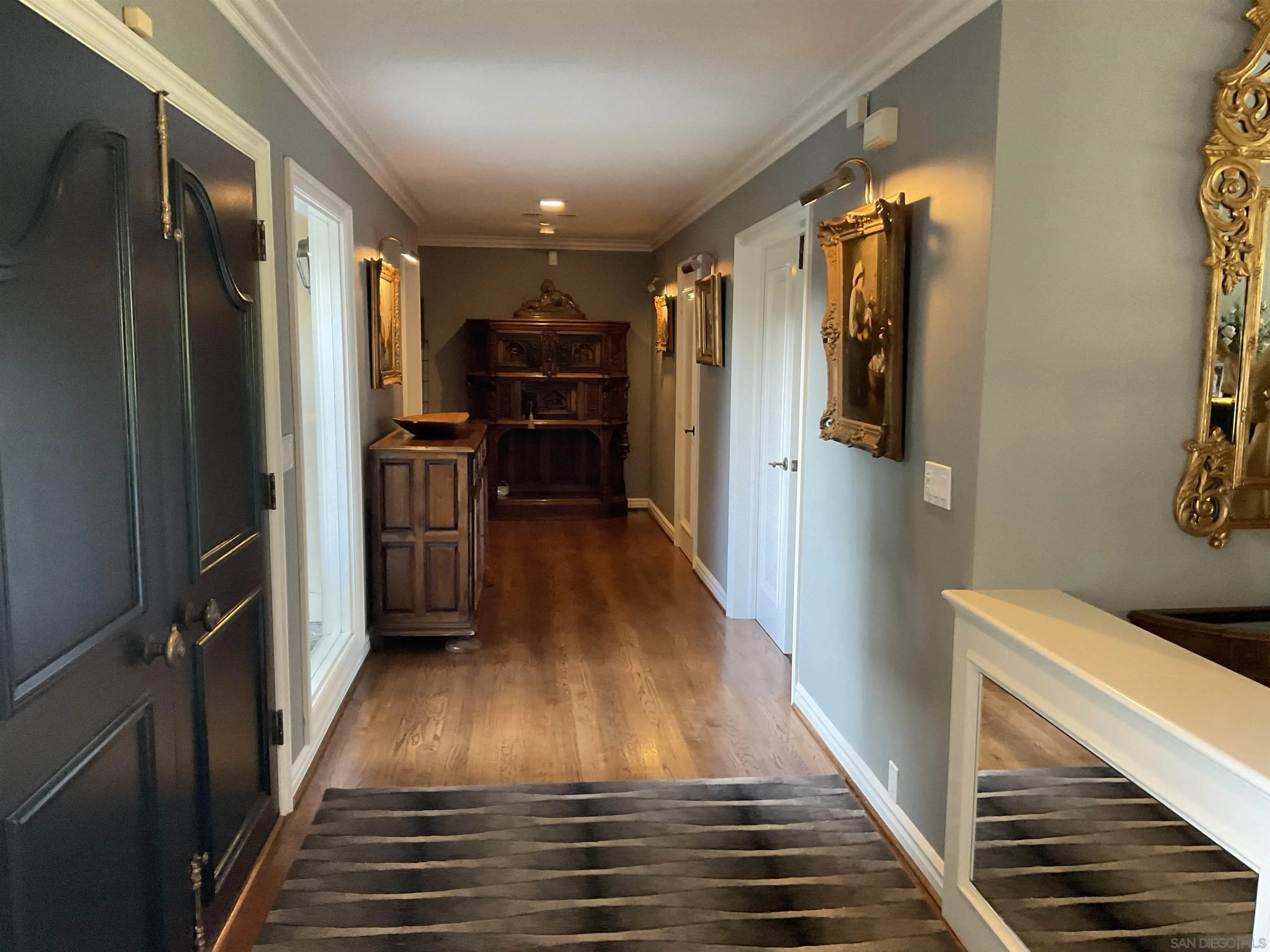 17532 Los Eucaliptos Rancho Santa Fe, CA 92067 - Photo 3 of 39 a view of entryway and hall with wooden floor
