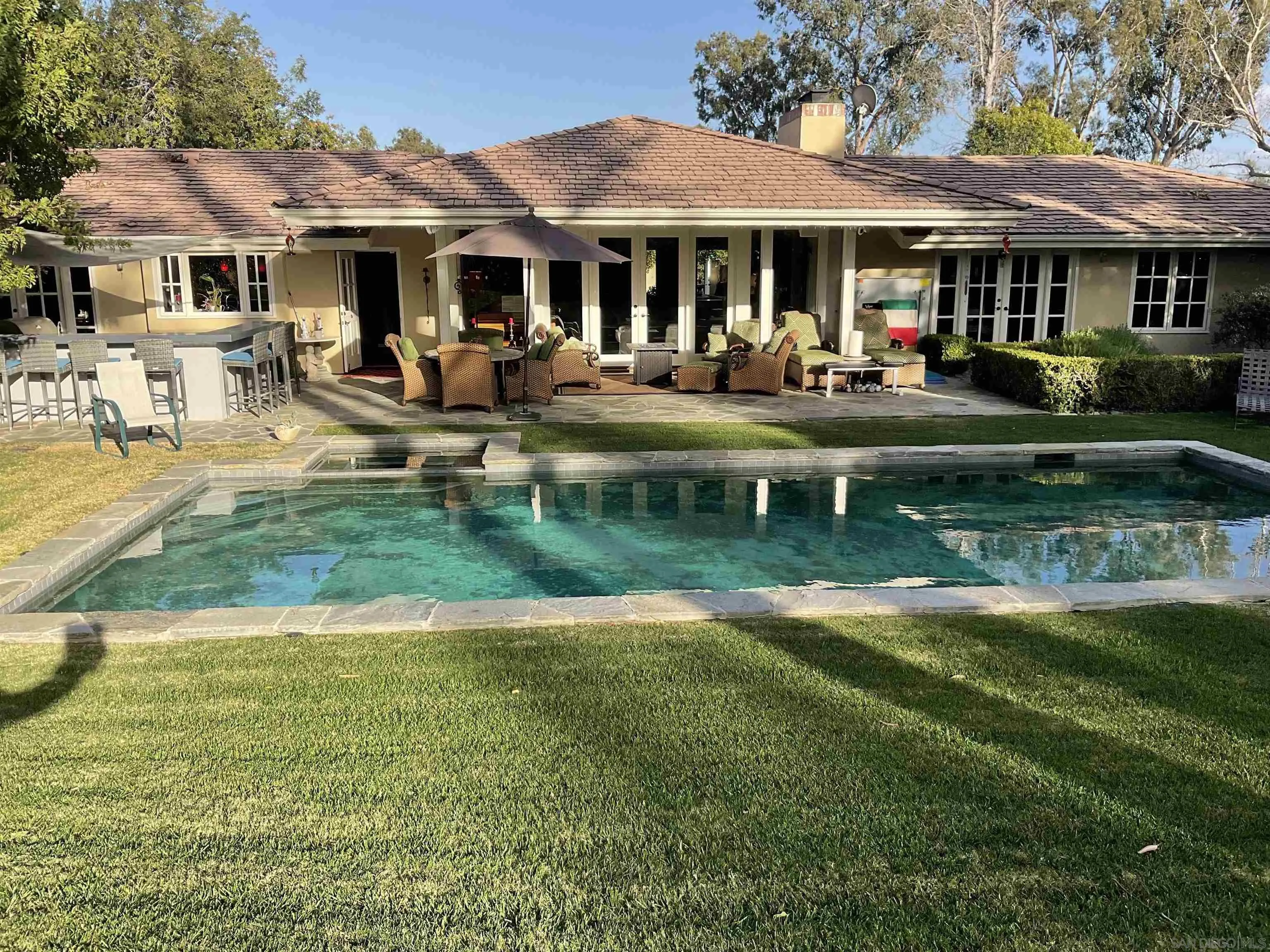 17532 Los Eucaliptos Rancho Santa Fe, CA 92067 - Photo 33 of 39 a front view of a house with garden and trees