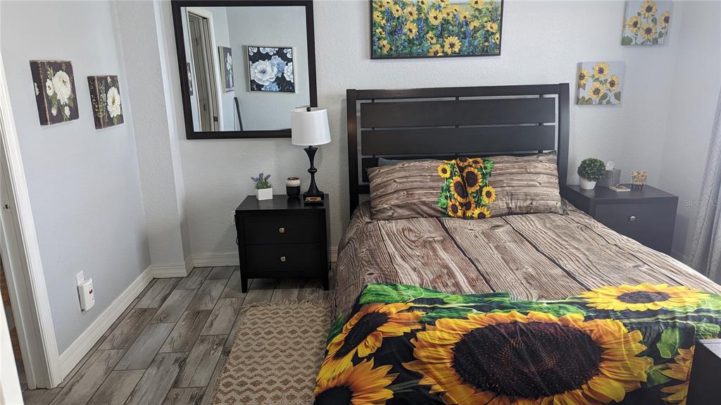 3101 Fallow Road Venice, FL 34293 - Photo 12 of 18 a bedroom with a bed and a painting on the wall