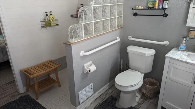 a bathroom with a toilet and a shower