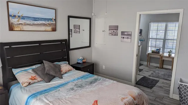 a bedroom with a bed and the view of kitchen