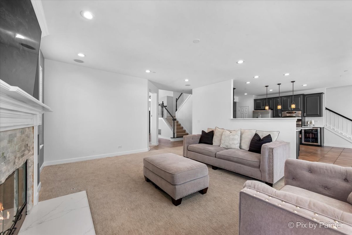 5919 Chatham Drive Hoffman Estates, IL 60192 - Photo 13 of 52 a living room with furniture and a fireplace