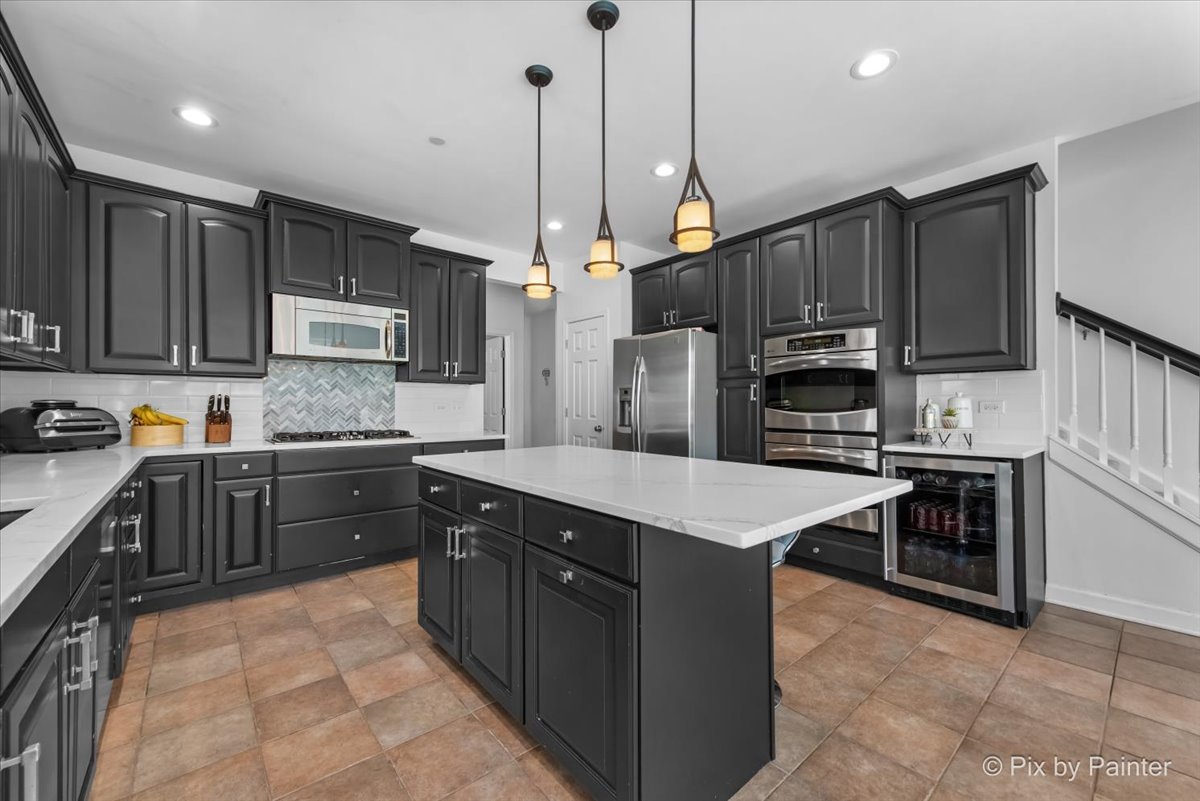 5919 Chatham Drive Hoffman Estates, IL 60192 - Photo 14 of 52 a kitchen with kitchen island a sink stainless steel appliances and cabinets