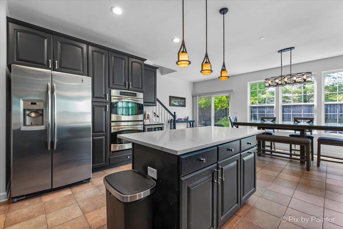 5919 Chatham Drive Hoffman Estates, IL 60192 - Photo 17 of 52 a kitchen with stainless steel appliances granite countertop a sink a stove and a refrigerator