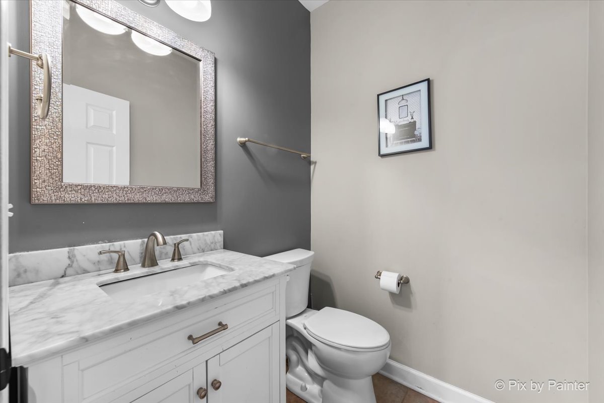 5919 Chatham Drive Hoffman Estates, IL 60192 - Photo 19 of 52 a bathroom with a granite countertop toilet sink and mirror