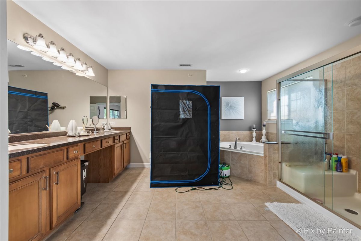 5919 Chatham Drive Hoffman Estates, IL 60192 - Photo 25 of 52 a kitchen with stainless steel appliances kitchen island granite countertop a refrigerator and a sink