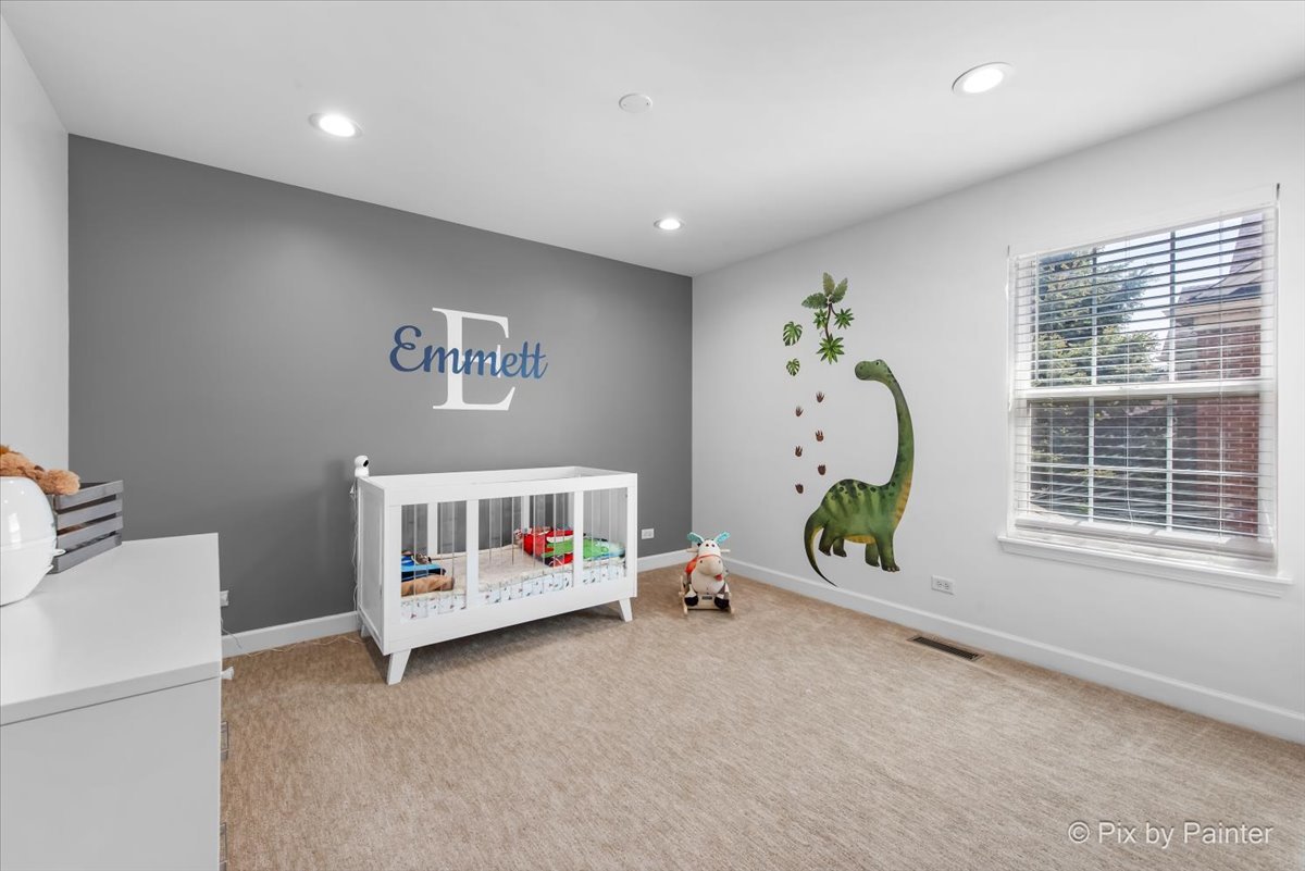 5919 Chatham Drive Hoffman Estates, IL 60192 - Photo 27 of 52 a bedroom with furniture and a window
