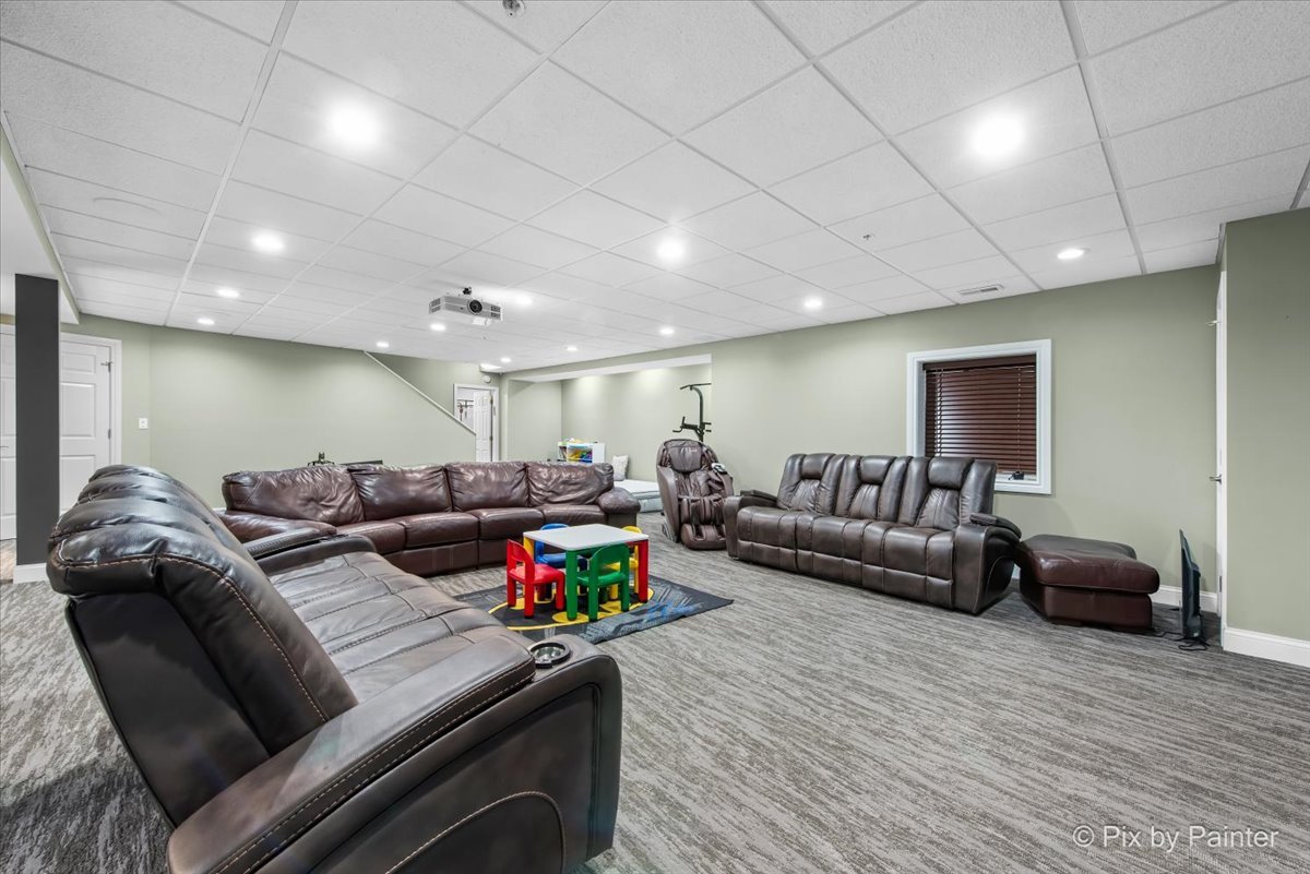 5919 Chatham Drive Hoffman Estates, IL 60192 - Photo 32 of 52 a living room with furniture and a wooden floor