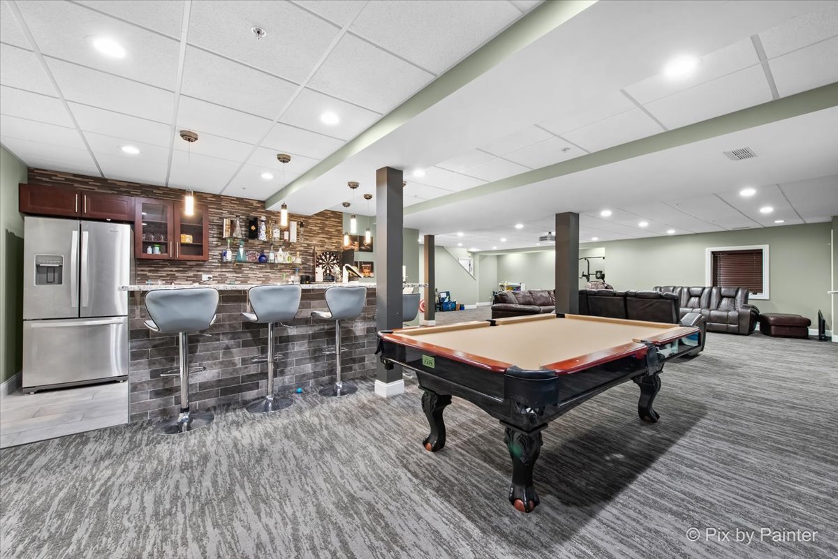 5919 Chatham Drive Hoffman Estates, IL 60192 - Photo 35 of 52 a room with lots of furniture and a view of a chandelier