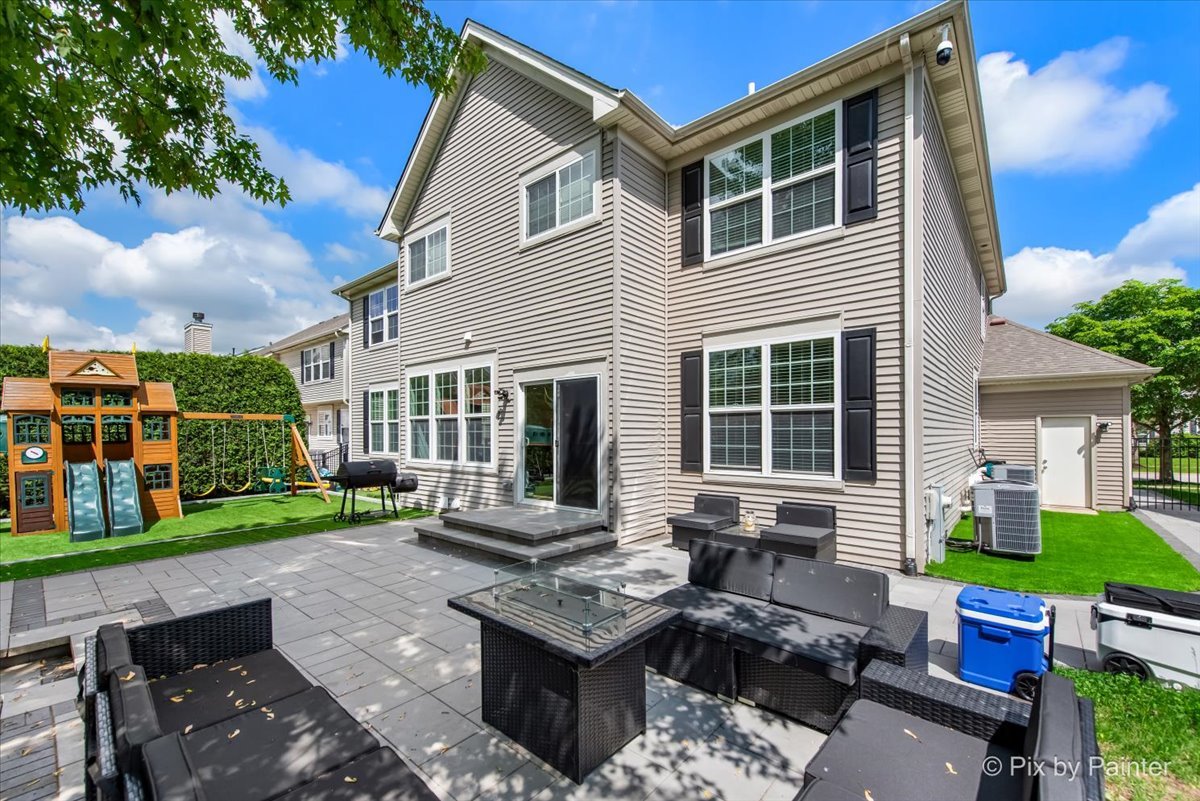 5919 Chatham Drive Hoffman Estates, IL 60192 - Photo 5 of 52 a view of a patio with couches table and chairs and potted plants