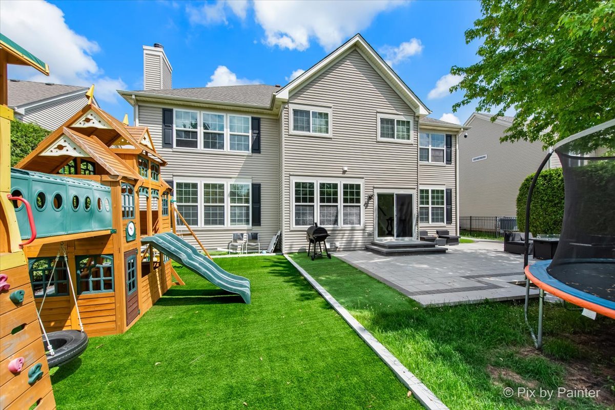 5919 Chatham Drive Hoffman Estates, IL 60192 - Photo 7 of 52 a view of house with a backyard and a patio