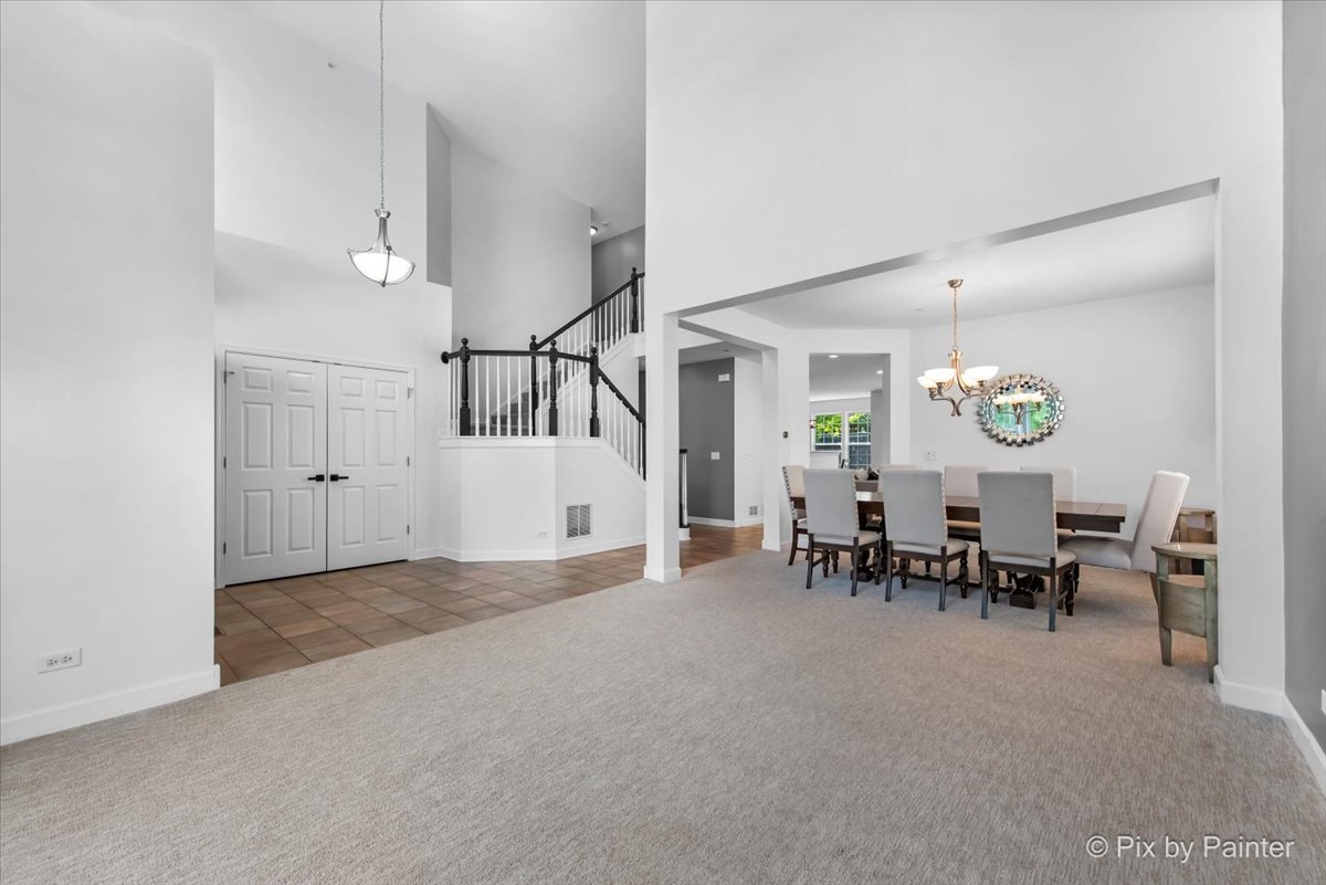 5919 Chatham Drive Hoffman Estates, IL 60192 - Photo 9 of 52 a view of a dining room and livingroom with furniture a table and chairs