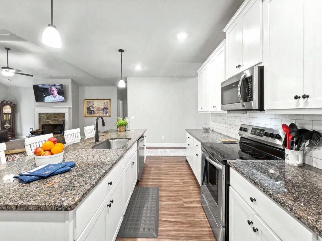 453 Mulberry Rock Road Temple, GA 30179 - Photo 11 of 35 a large kitchen with stainless steel appliances granite countertop a stove and a sink
