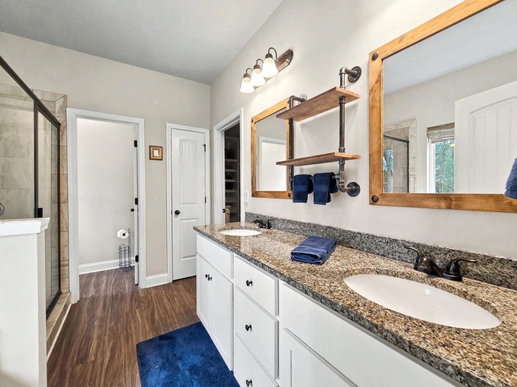 453 Mulberry Rock Road Temple, GA 30179 - Photo 17 of 35 a spacious bathroom with a granite countertop double vanity sink a mirror and a shower