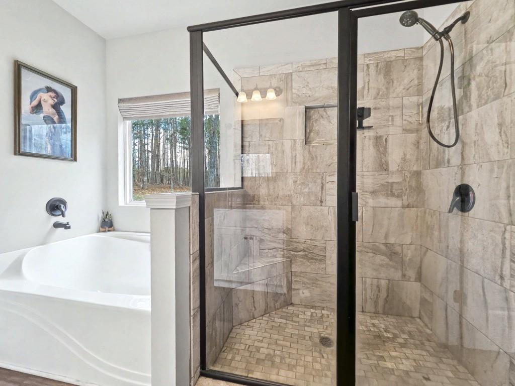 453 Mulberry Rock Road Temple, GA 30179 - Photo 18 of 35 a bathroom with a bathtub and a shower