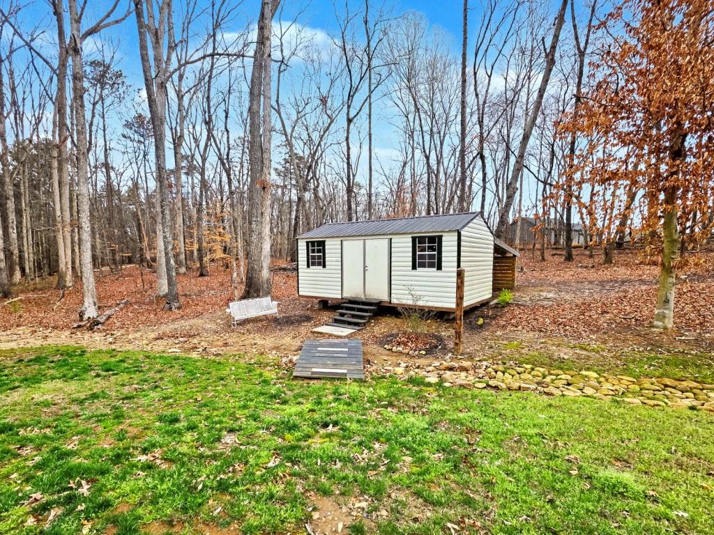 453 Mulberry Rock Road Temple, GA 30179 - Photo 30 of 35 a backyard of a house with table and chairs