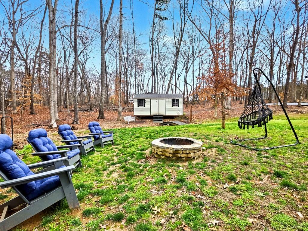 453 Mulberry Rock Road Temple, GA 30179 - Photo 32 of 35 a view of backyard with table and chairs and a large tree