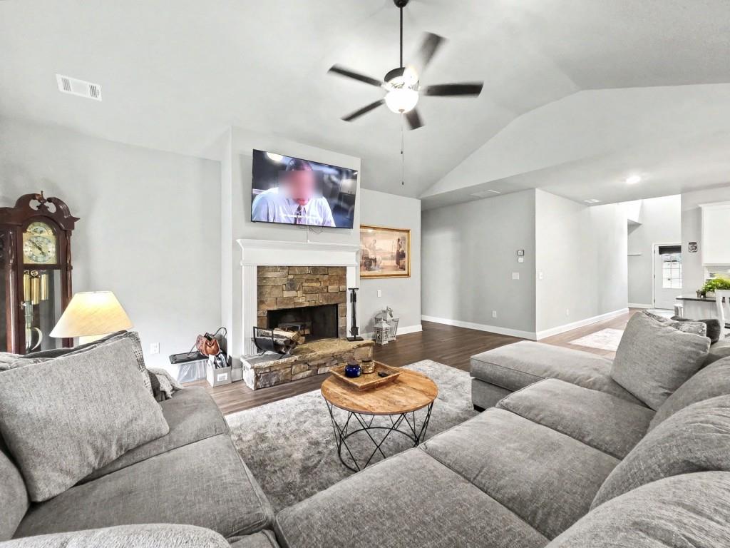 453 Mulberry Rock Road Temple, GA 30179 - Photo 10 of 35 a living room with furniture a fireplace and a flat screen tv