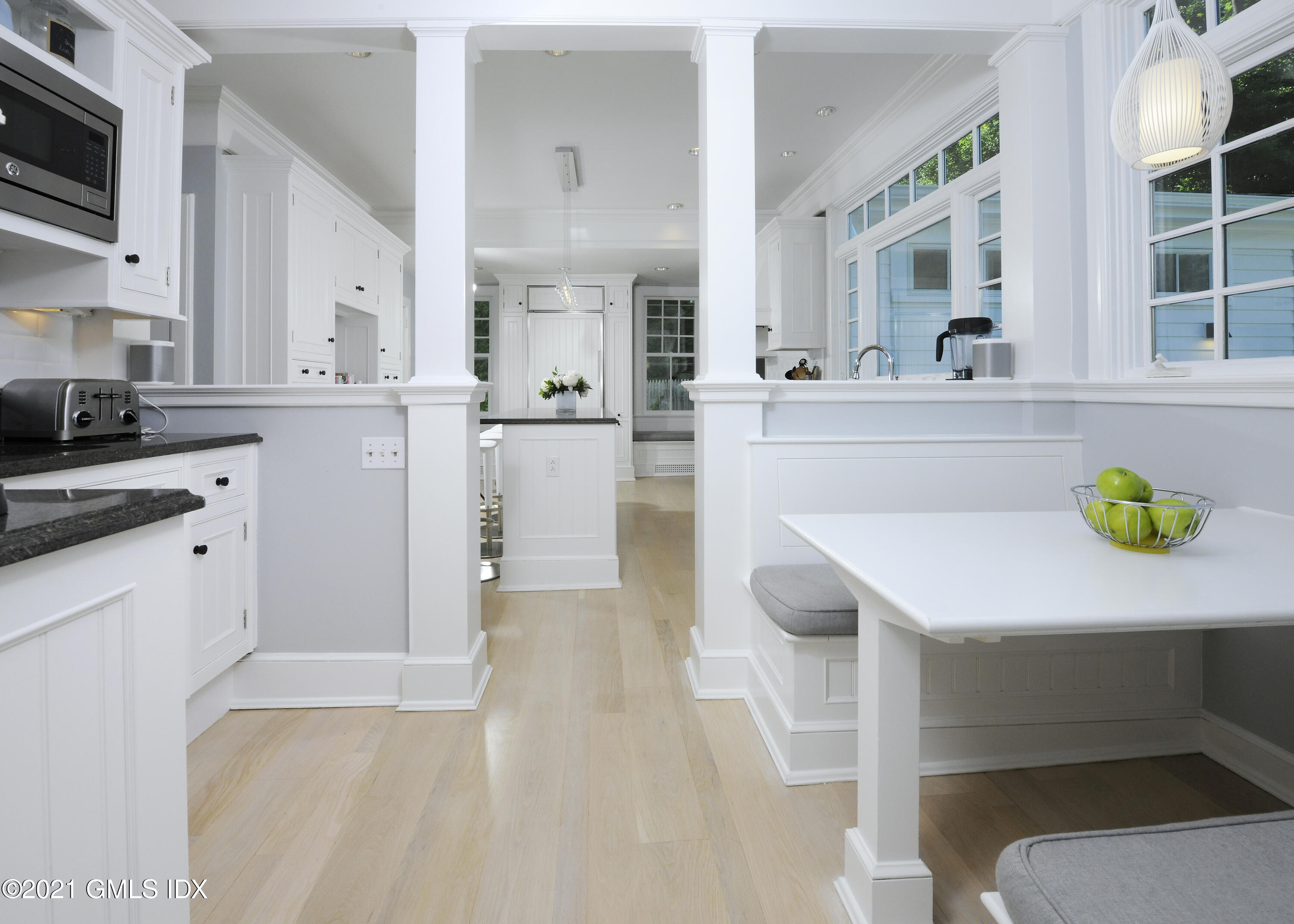 12 Binney Lane Old Greenwich, CT 06870 - Photo 11 of 28 a kitchen with a table chairs refrigerator and cabinets