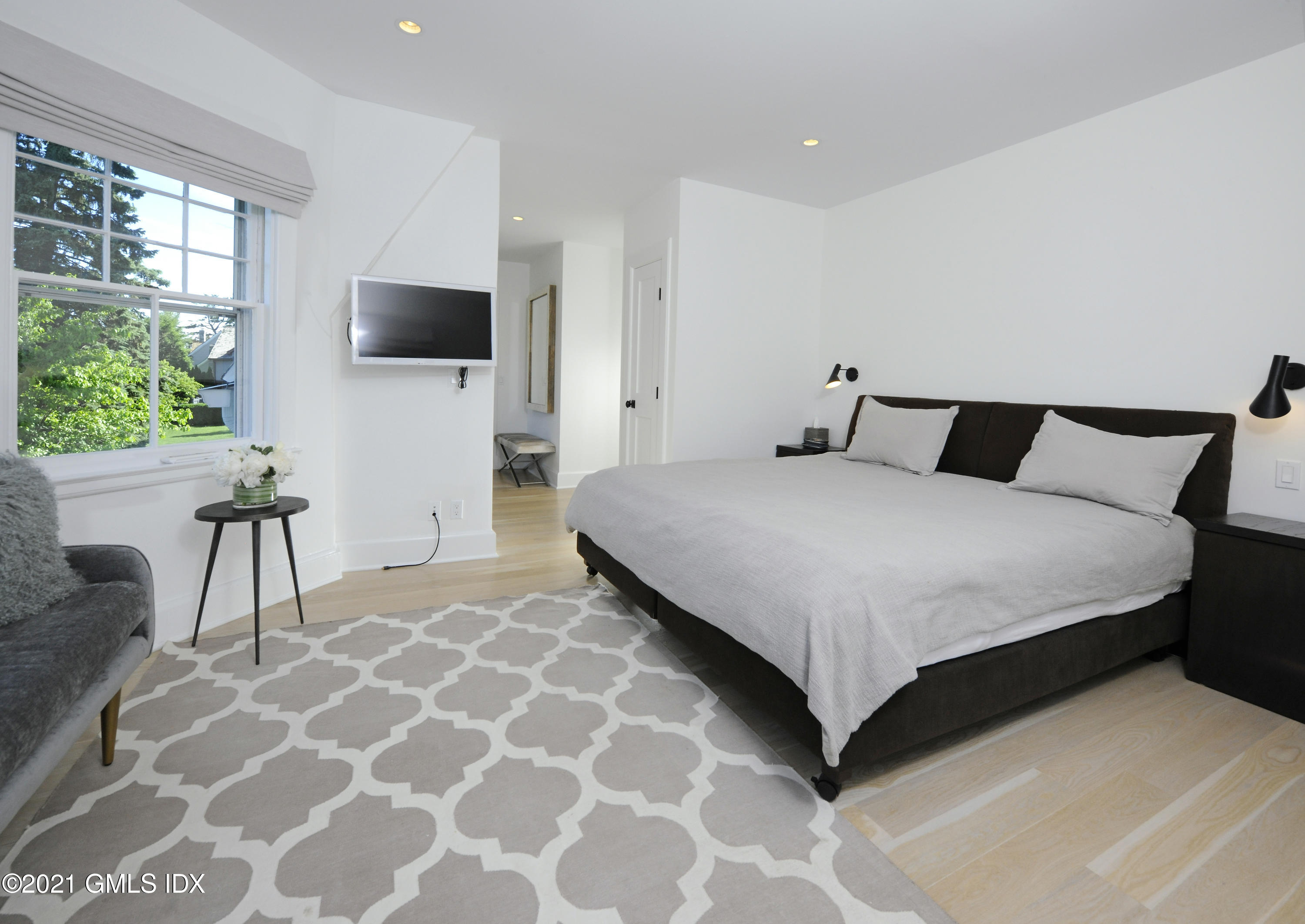 12 Binney Lane Old Greenwich, CT 06870 - Photo 13 of 28 a large bedroom with a bed and a flat screen tv