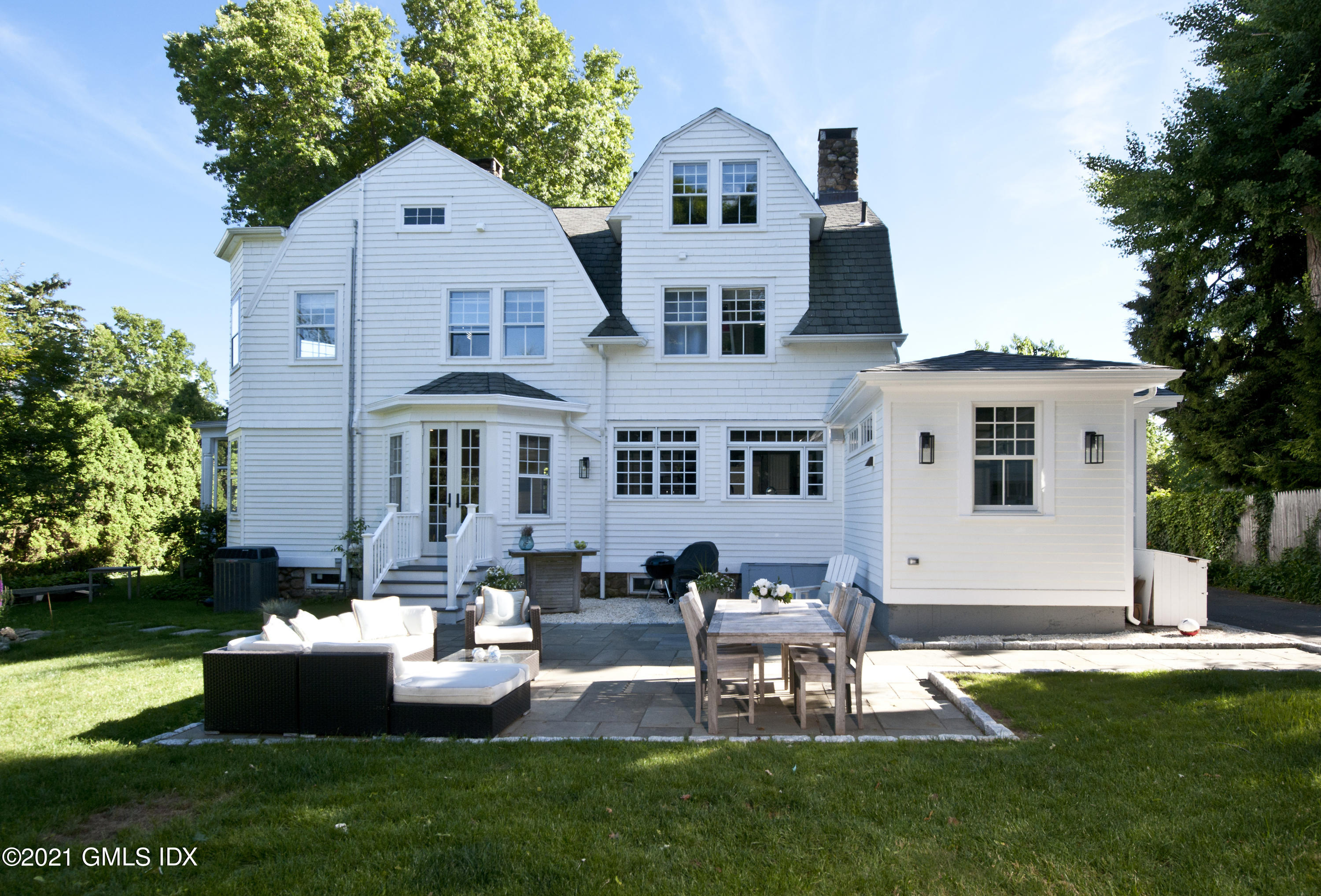 12 Binney Lane Old Greenwich, CT 06870 - Photo 22 of 28 a front view of a house with a garden and patio