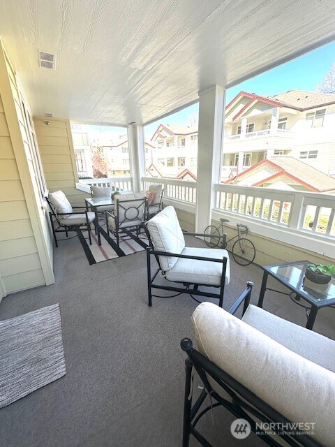 23943 Northeast 115th Lane, Unit 204 Redmond, WA 98053 - Photo 20 of 24 a living room with furniture and a floor to ceiling window