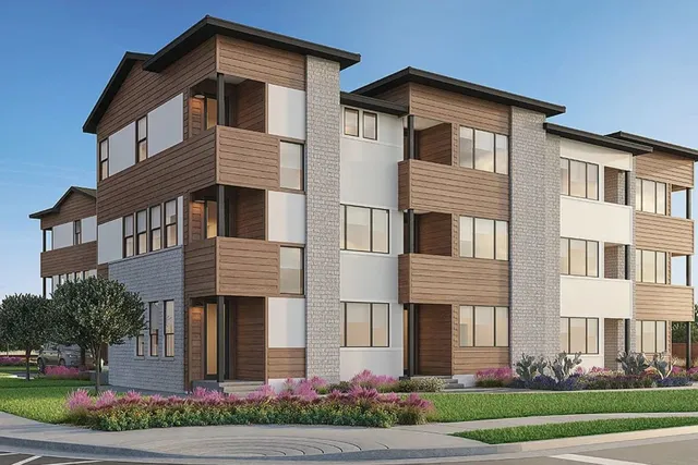 a front view of a house with a yard and potted plants