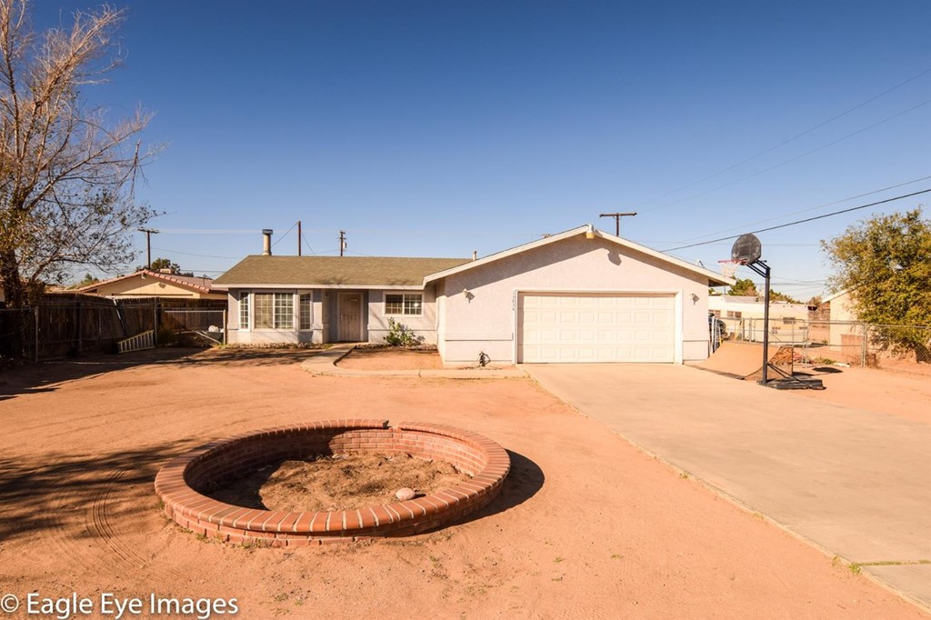 13834 Osage Road Apple Valley, CA 92307 - Photo 1 of 1 a front view of a house with a yard