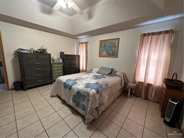 a bedroom with a bed and a television