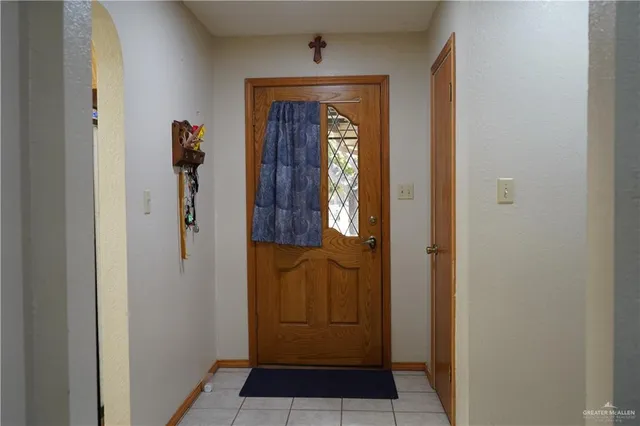 a view of a yard with wooden fence and a tree