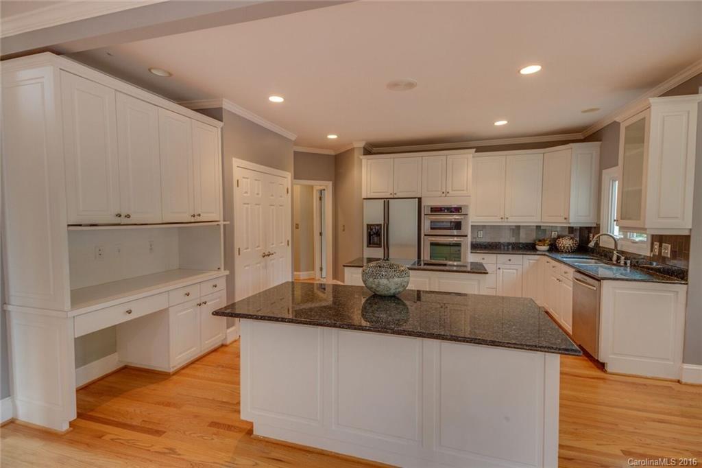 166 Lake Pointe Drive, Unit 122 Fort Mill, SC 29708 - Photo 14 of 22 a large kitchen with kitchen island a sink stainless steel appliances and cabinets