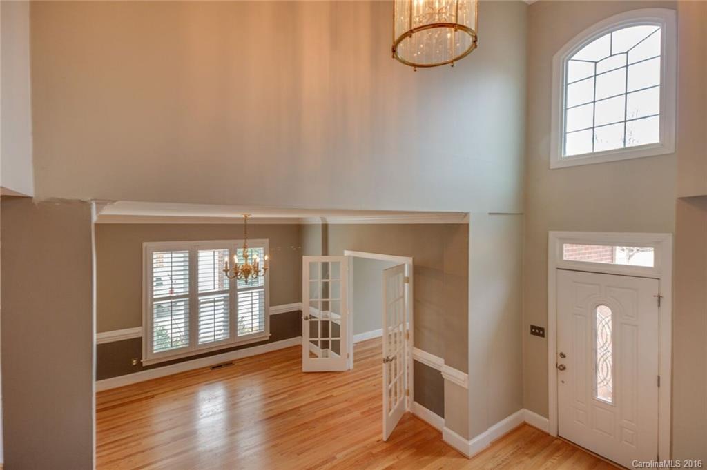 166 Lake Pointe Drive, Unit 122 Fort Mill, SC 29708 - Photo 9 of 22 an empty room with wooden floor and windows
