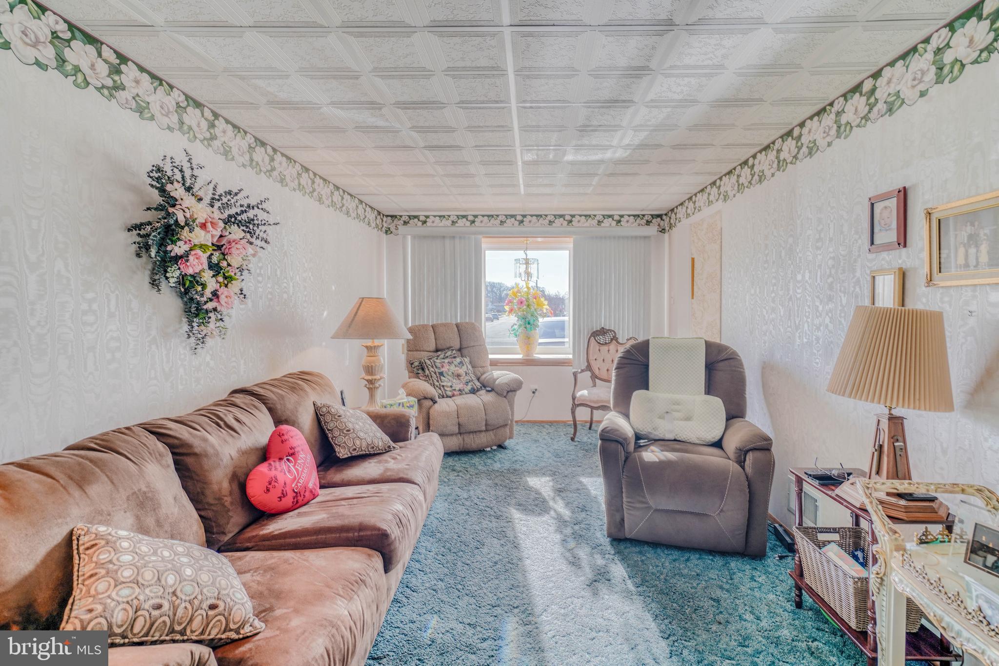 1137 Layton Road Philadelphia, PA 19115 - Photo 11 of 48 a living room with furniture and a chandelier