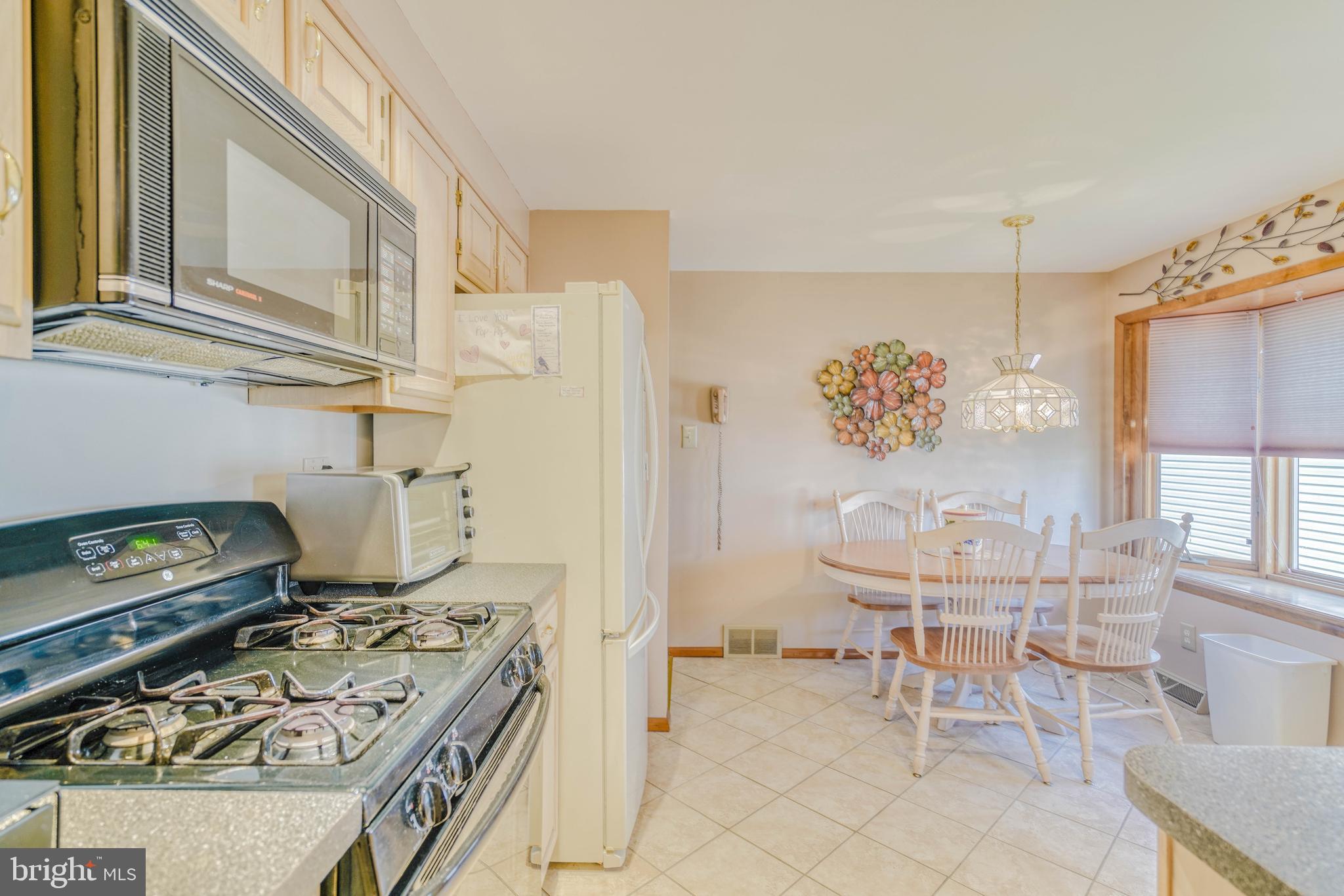 1137 Layton Road Philadelphia, PA 19115 - Photo 22 of 48 a kitchen with a stove and a table