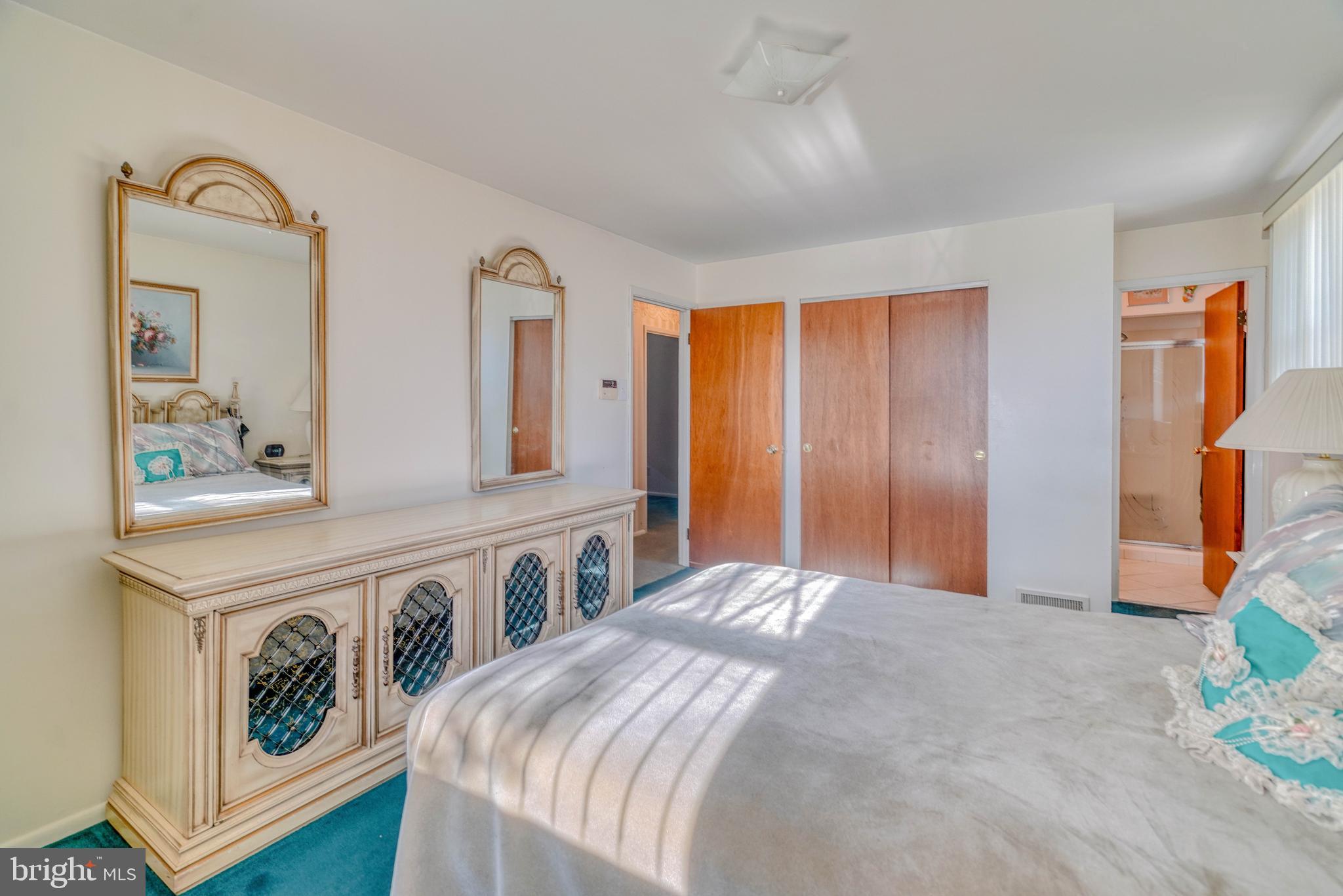 1137 Layton Road Philadelphia, PA 19115 - Photo 24 of 48 a bedroom with a bed and a dresser with mirror