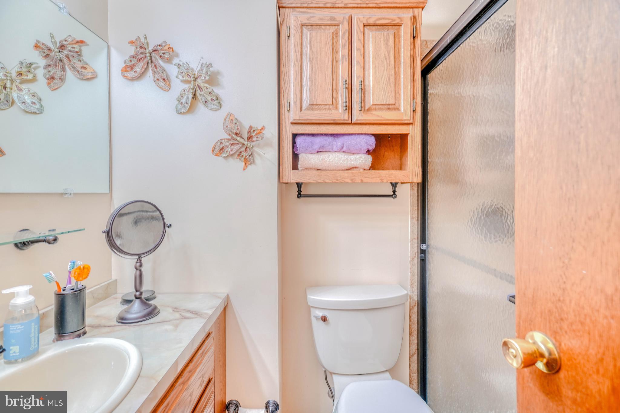 1137 Layton Road Philadelphia, PA 19115 - Photo 32 of 48 a bathroom with a granite countertop toilet sink and mirror