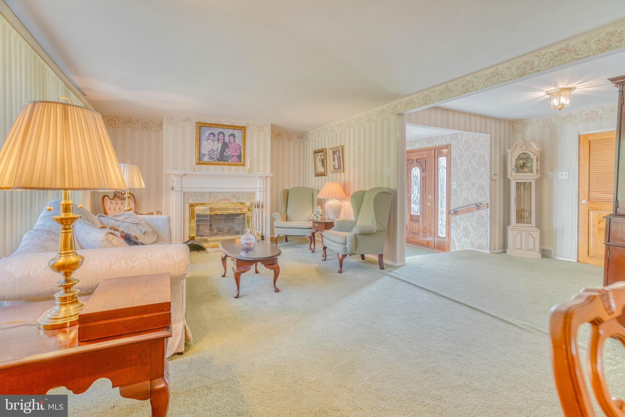 1137 Layton Road Philadelphia, PA 19115 - Photo 4 of 48 a living room with furniture a lamp and a fireplace