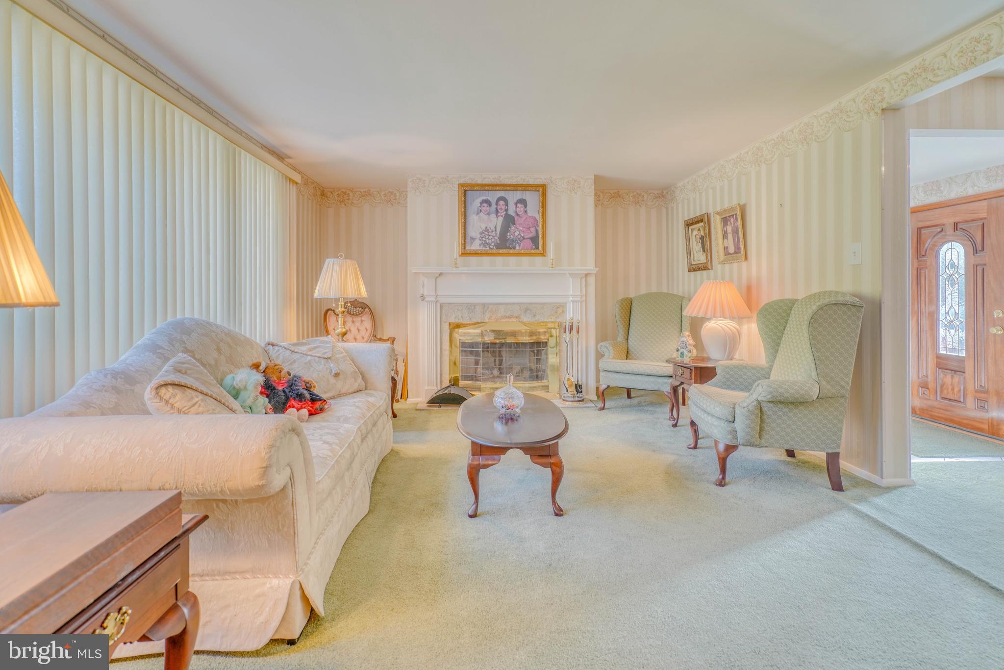 1137 Layton Road Philadelphia, PA 19115 - Photo 10 of 48 a living room with furniture and a fireplace