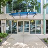 a view of a white house with large windows and plants
