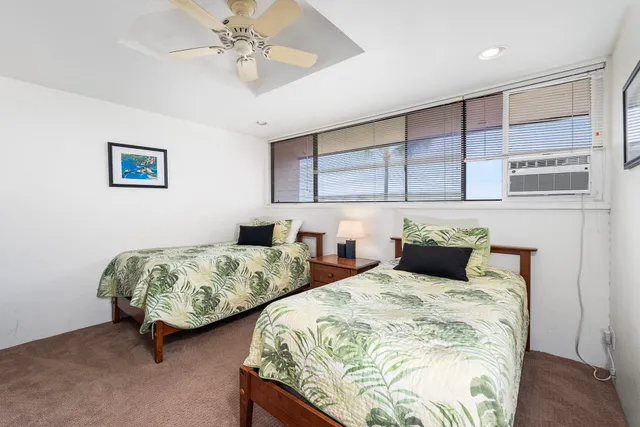 a bedroom with two beds and a chandelier