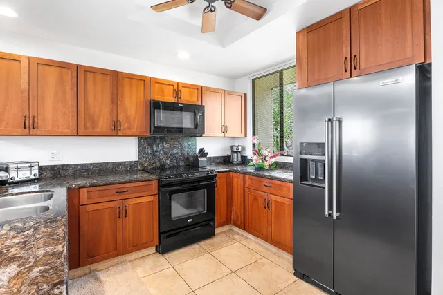 a kitchen with stainless steel appliances granite countertop a refrigerator and a sink
