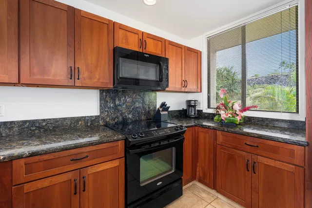 a kitchen with stainless steel appliances granite countertop a sink stove and microwave
