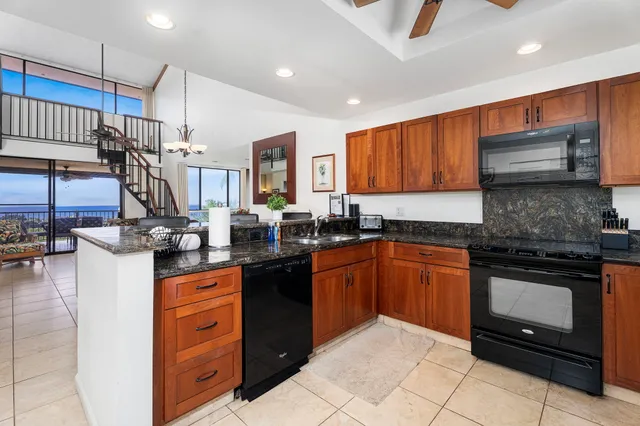 a kitchen with stainless steel appliances granite countertop a stove sink and cabinets