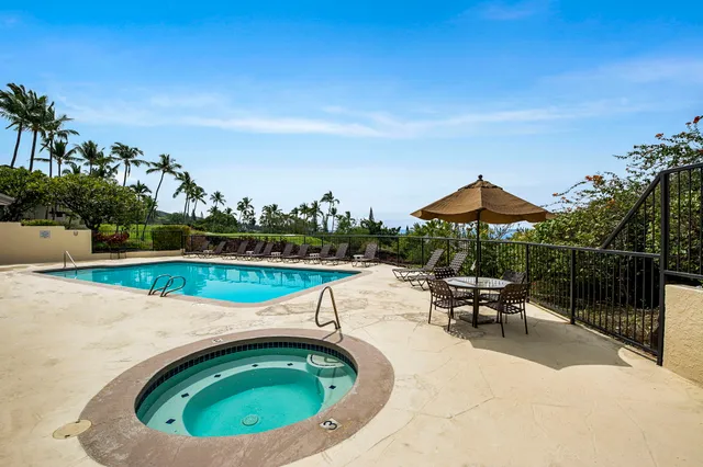 swimming pool view with a seating space