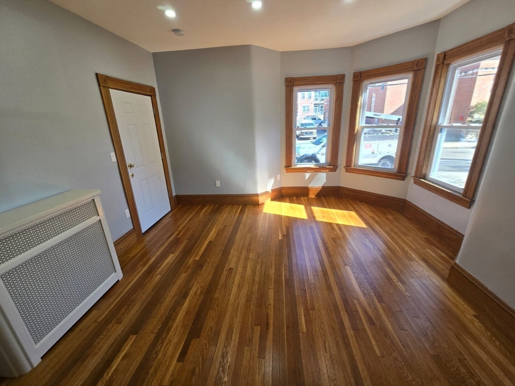22 Linden Street Reading, MA 01867 - Photo 14 of 32 a view of an empty room with wooden floor and a window