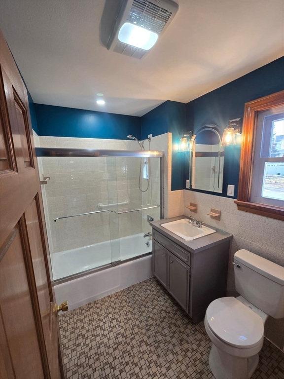 22 Linden Street Reading, MA 01867 - Photo 18 of 32 a bathroom with a sink a toilet a mirror and shower