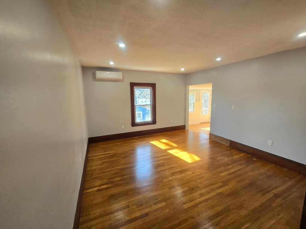 22 Linden Street Reading, MA 01867 - Photo 21 of 32 a view of empty room with wooden floor and fan
