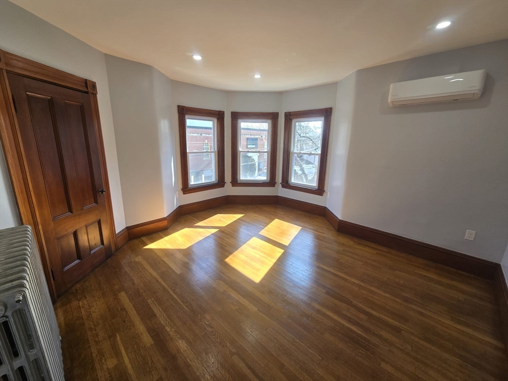 22 Linden Street Reading, MA 01867 - Photo 24 of 32 a view of empty room with wooden floor and fan