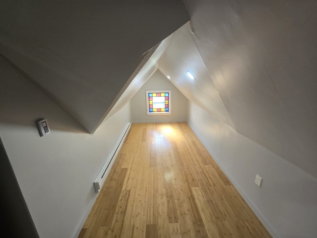 22 Linden Street Reading, MA 01867 - Photo 7 of 32 a view of a hallway with wooden floor and window