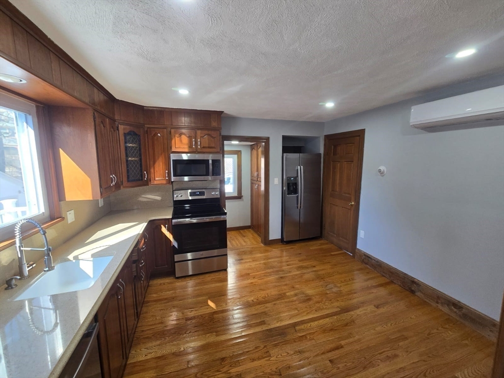22 Linden Street Reading, MA 01867 - Photo 10 of 32 a view of a kitchen with a sink and a stove top oven